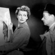 woman shows man a painting