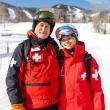 Man, teen girl ski patrollers