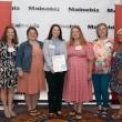 Six women pose in front of MaineBiz backdrop