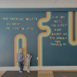 children lean against a decorated wall