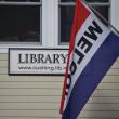 library sign and welcome flag