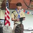 Scout looks at award during ceremony