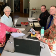five adults sit at a table