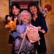 two women pose with puppets