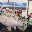 woman, children with big fake fish