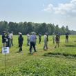 people walk through a field
