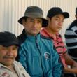 four men look at camera