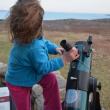 young child gripping telescope