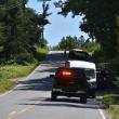emergency vehicles face crest of hill