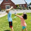 two children play a lawn game