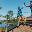 two men on roof hi-five