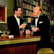 two men sing at bar