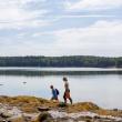 two women walking as they survey for oysters