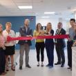 eight adults at ribbon cutting