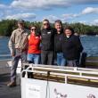 people pose for picture in boat
