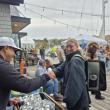 Mast Landing's Gabe Vickery hands Kathryn Rogers from Owls Head a beer as she, and her backpack buddy, Ziggy, enjoy the festival. Photo by Kay Stephens