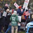 crowd, words on back of green coat