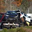 two vehicles loaded on flat beds