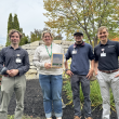 four people in front of garden