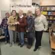 five women pose with check