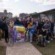 large, multi-generation group poses with donation