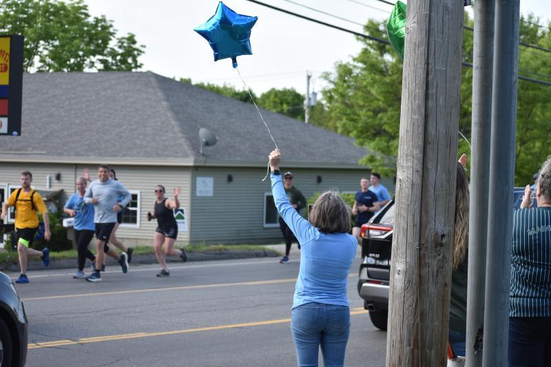 Maine State Credit Union workers rally for Special Olympics during the 2024 Law Enforcement Torch Run for Special Olympics. (Photo by Sarah Thompson)