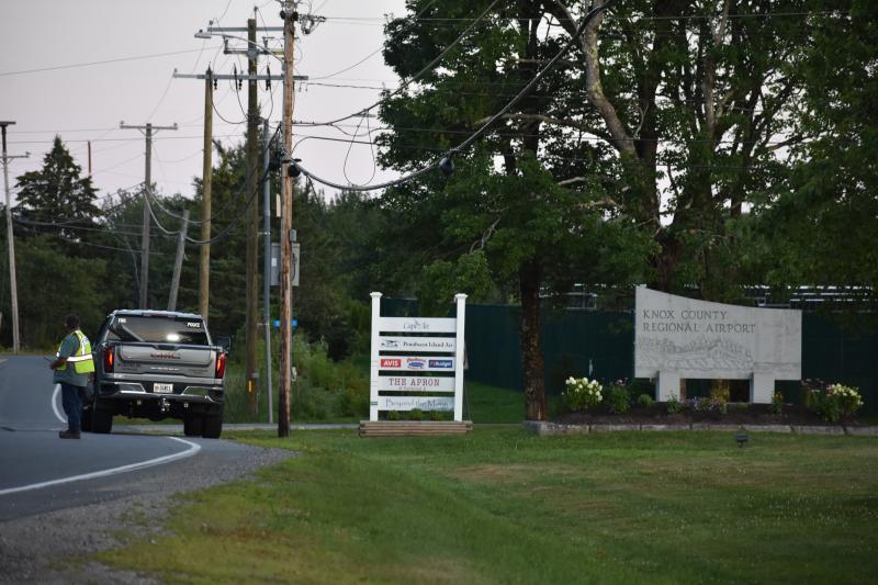 An Owls Head firefighter slows traffic on Ash Point Drive, Friday evening, Aug. 1, 2025, while officials search for a possible plane crash. (Photo by Sarah Thompson)