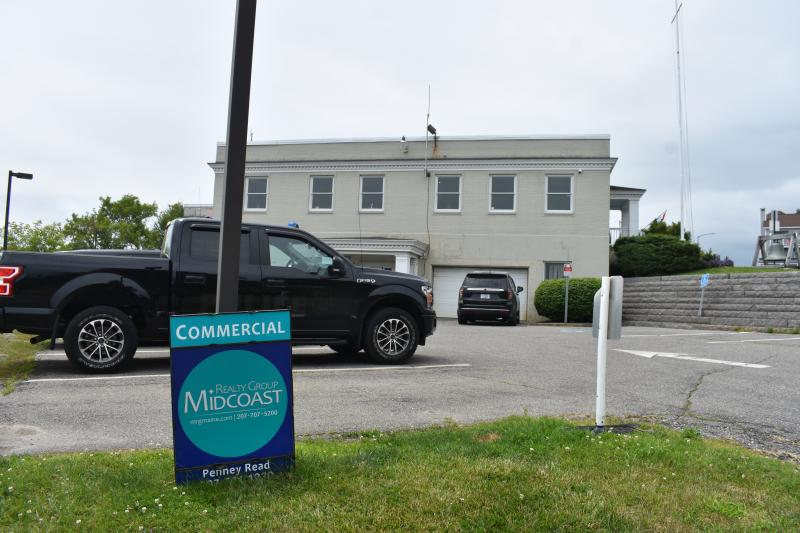 Police station parking lot with for sale sign