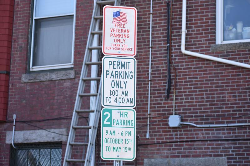 three signs on a vertical pole