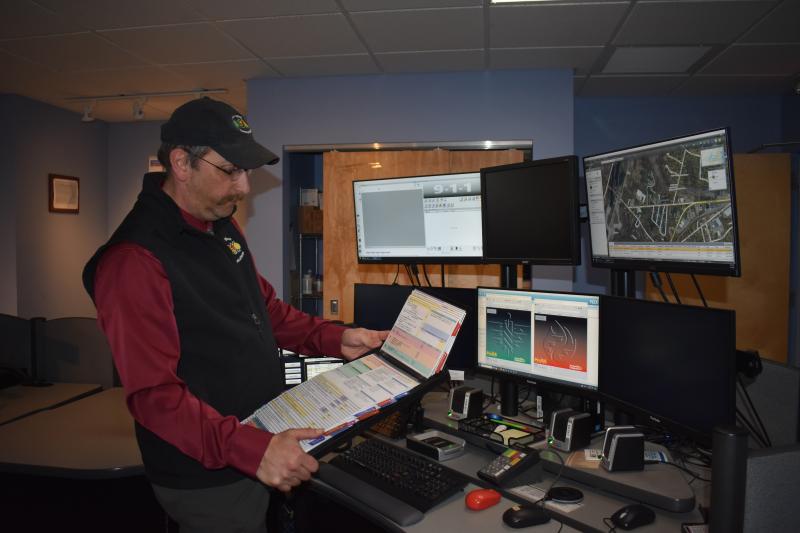 File Photo Knox Regional Communications Center director Robert Coombs shows an algorithm of emergency medical cards that lead dispatchers to certain medical situations based on responses by the 911 caller. (Photo by Sarah Thompson)