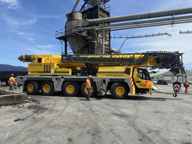 yellow crane truck at lumber yard