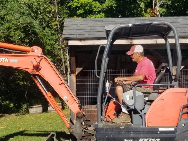 man operates backhoe