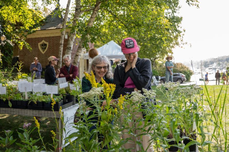 two women look at plants