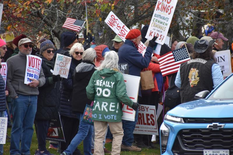 crowd, words on back of green coat