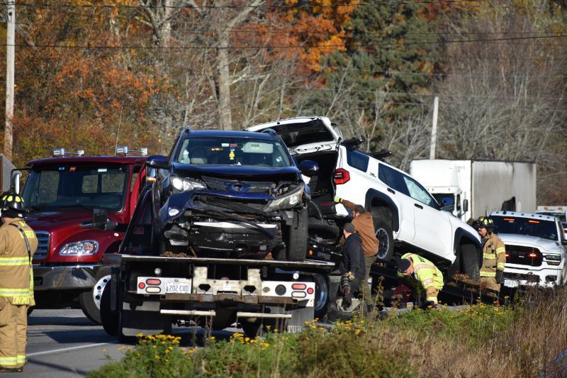 two vehicles loaded on flat beds