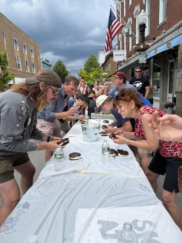 people at long table competing