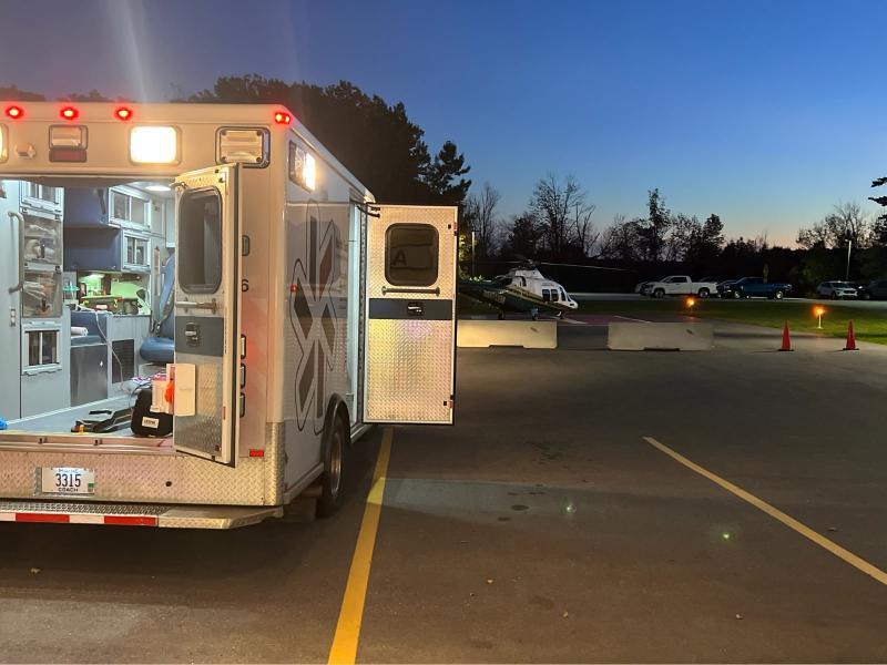 Camden Fire and Rescue and North East Mobile Health Service first responders transfer a cardiac arrest patient from the back of the ambulance to a waiting LifeFlight 