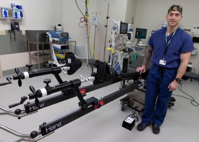 Dr. Zethariah Zielinski stands and surgery table