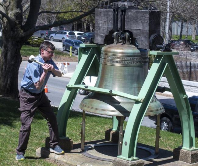 Peter Crockett rings a giant memorial bell