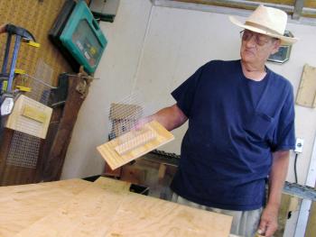 In his workshop, Adrian Turner shows the wire mesh interior of one of his bat houses. (Photo by Ethan Andrews) In his workshop, Adrian Turner shows the wire mesh interior of one of his bat houses.