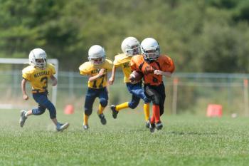Three Medomak players race after a Rockland Tiger as he goes for the score. Photo by Ron Hawkes