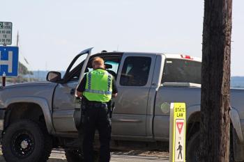 A Rockland police officer talks to the driver of the pickup truck involved in Thursday's accident on Camden Street.