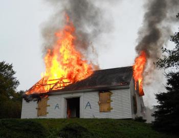 After lighting and extinguishing 14 training fires, a final fire is lit and the old house is allowed to burn. (Photo courtesy Bryan Calderwood)