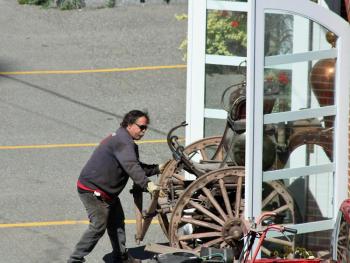 Leading the way, Andy Swift joins Camden firefighters in moving the town's 1892 steam fire pumper outside for a "spit and shine."