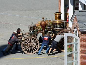 After moving the antique steam fire pumper out of its viewing room at the Camden Fire Station Tuesday, it's pushed back into a bay at the fire station.