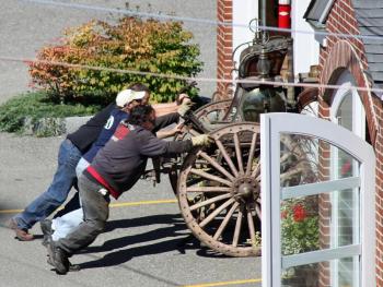 A little more muscle is needed to get Camden's antique steam fire pumper inside the fire station, where some preservation work soon got underway Tuesday.