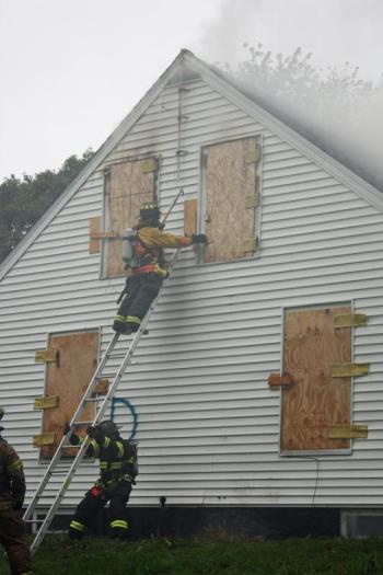 Practicing safe ladder techniques. (Photo by Holly S. Edwards)