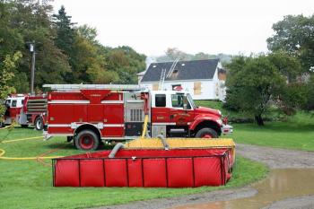 Water shuttled from a nearby fire pond is stored in a portable pool until its needed Saturday. (Photo by Holly S. Edwards)
