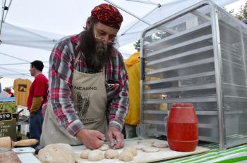 Dusty Dowes of the Maine Grain Alliance makes free bread samples.