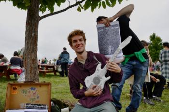Musician Devon Cole, aka Earth Person, sells his new album to fairgoers.